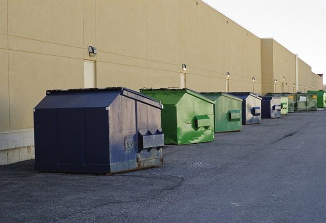 a series of colorful, utilitarian dumpsters deployed in a construction site in Cuttingsville